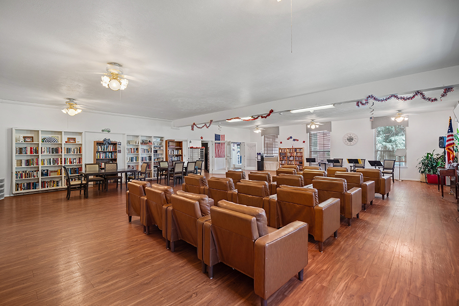 Spacious community room with seating and bookshelves.