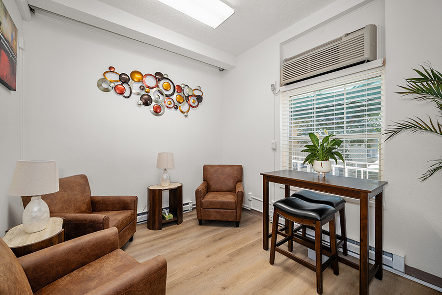 Cozy room with seating, art, and natural light.
