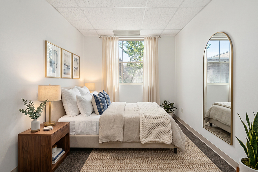 Cozy, minimalistic bedroom with natural light and soft decor.