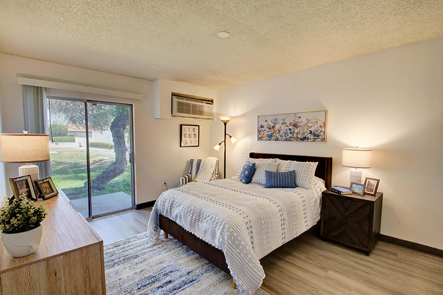 Cozy bedroom with natural light and comfortable furnishings.