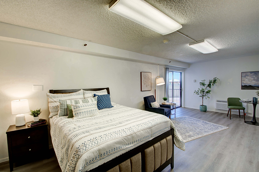 Cozy bedroom with modern furnishings and natural light.
