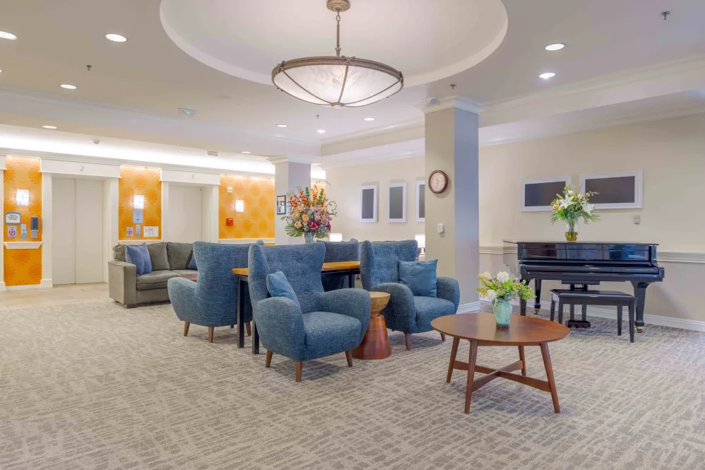 Modern lounge with comfortable seating and piano.