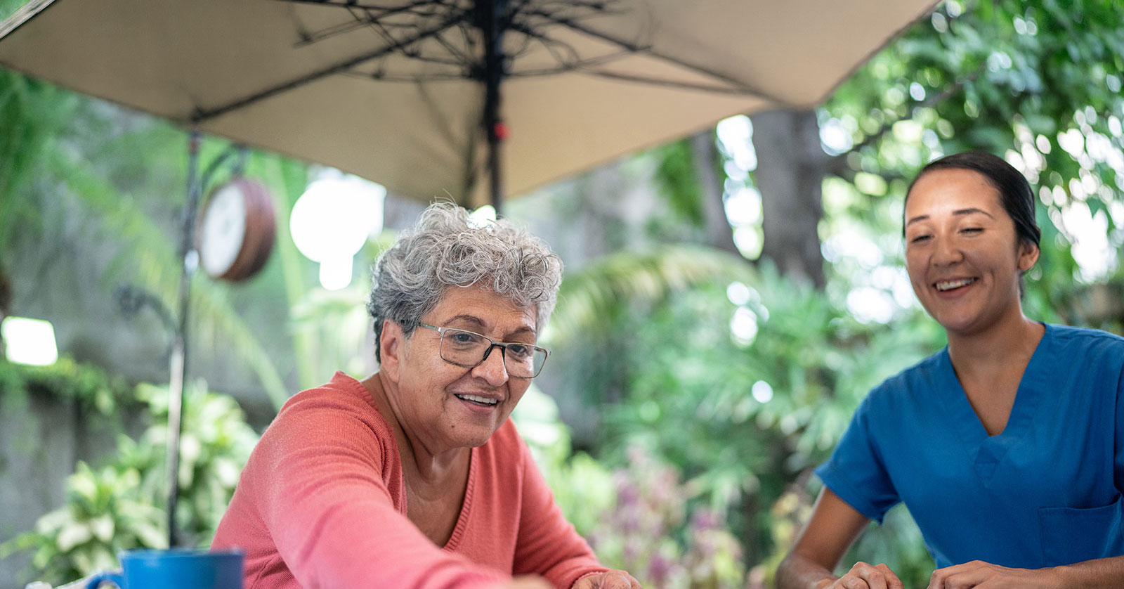 Two women enjoying a game outdoors, smiling and engaged.
