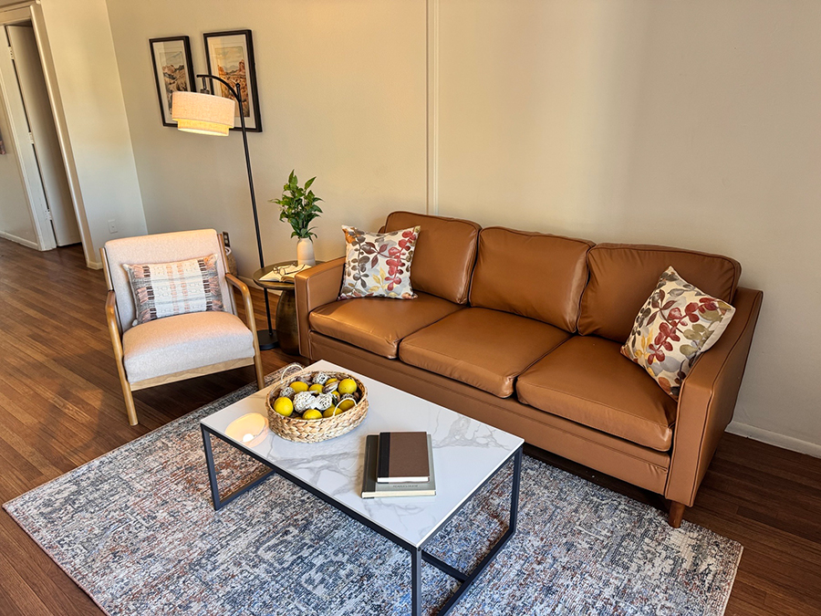 Cozy living room with couch, chair, and decorative table.