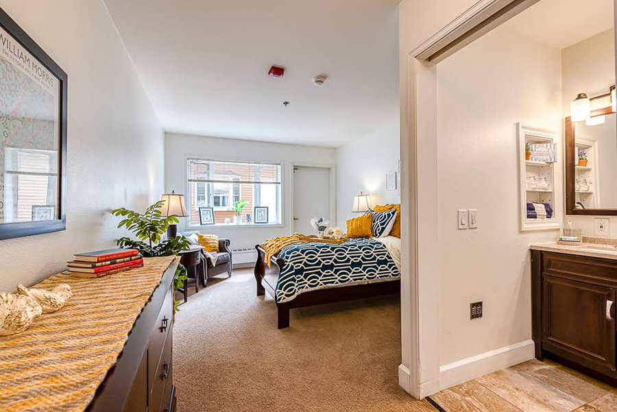 Bright, cozy bedroom with connected bathroom area.