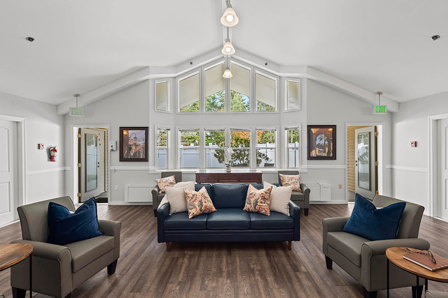 Bright, open lounge with comfortable seating and large windows.