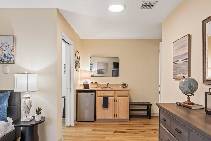 Cozy room with kitchenette and decorative elements.