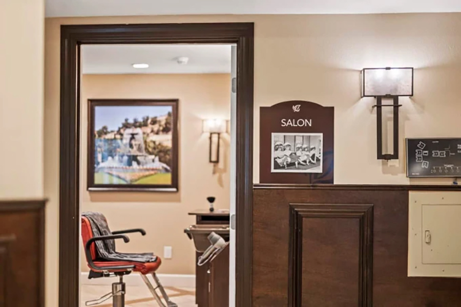 Salon entrance with a chair and decorative elements visible.