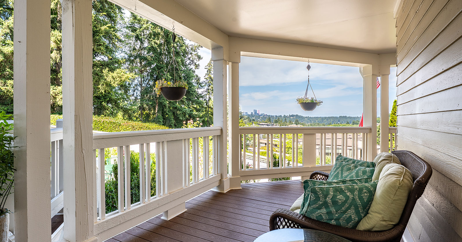 Sunny porch with comfortable seating and scenic views.