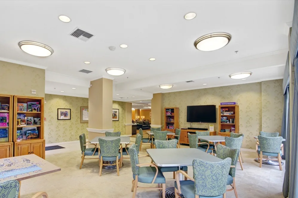 Bright communal space with seating and bookshelves.
