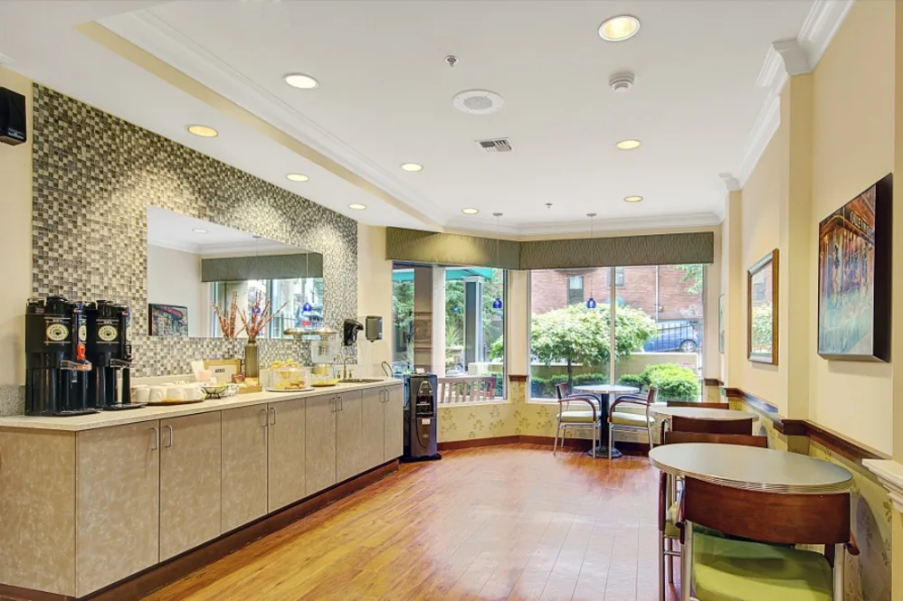 Bright, modern café space with seating and beverage station.