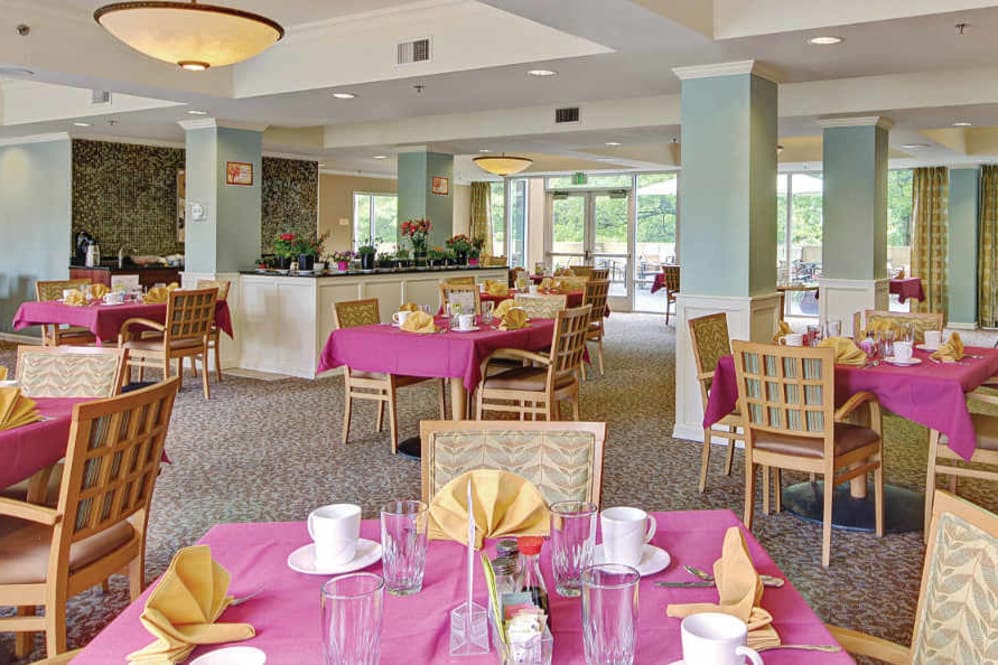 Casual dining area with pink tablecloths and natural light.