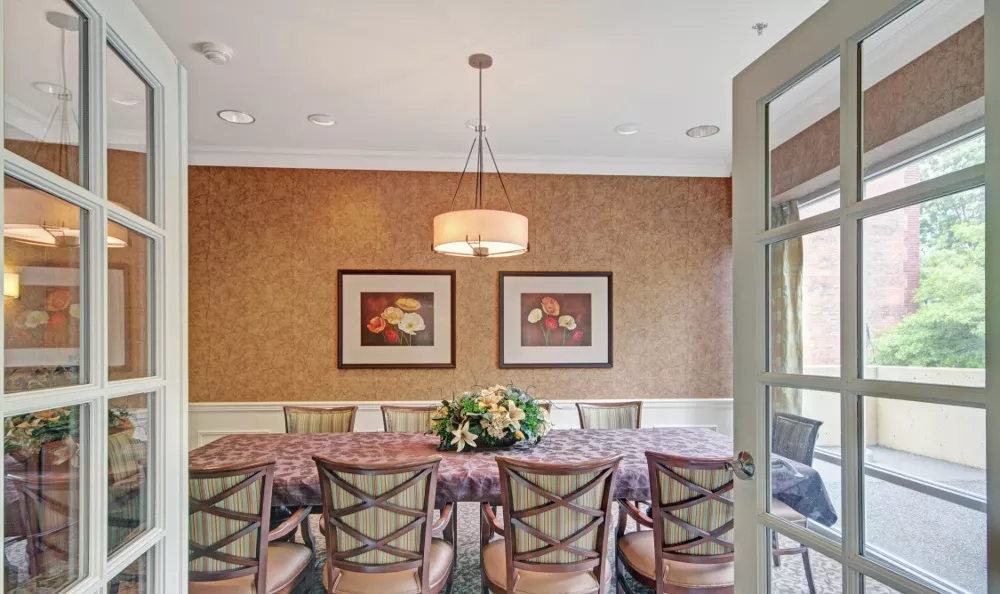 Elegant dining room with floral decor and large table.