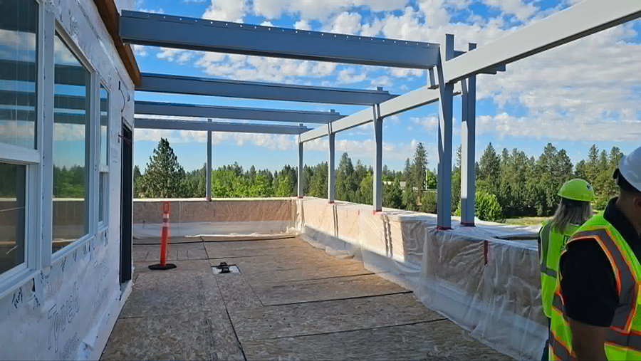 Construction site with open framework and scenic background.