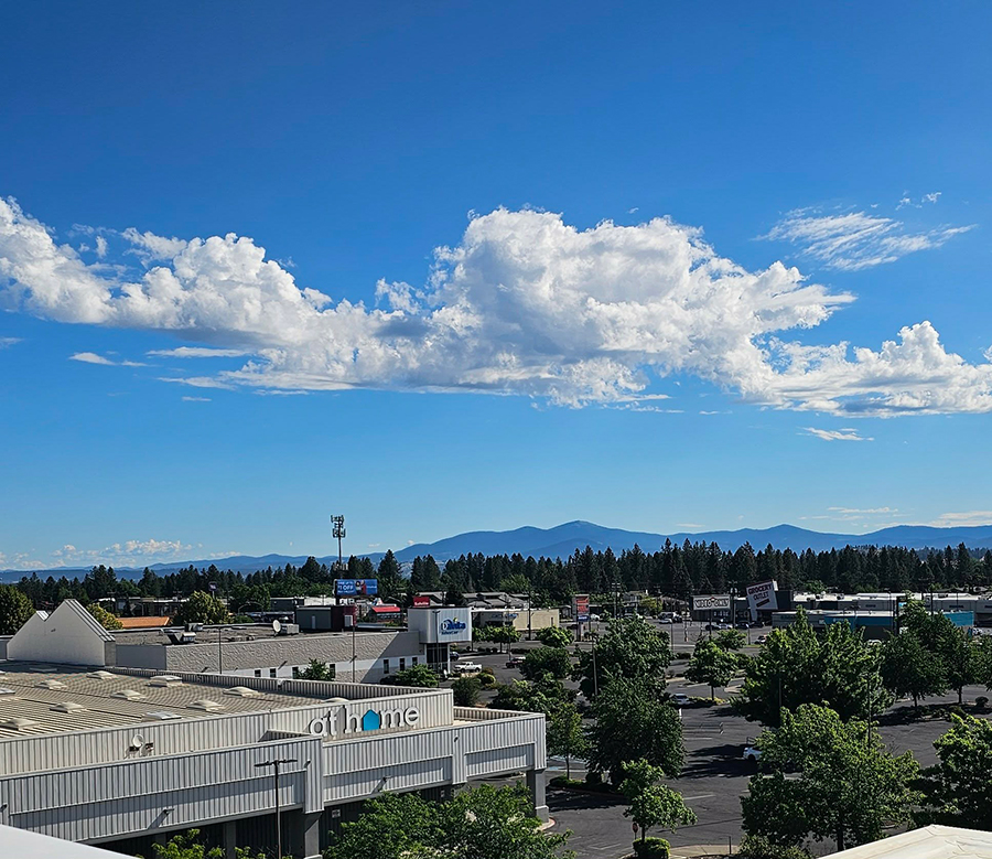 Clear blue sky over mountains and shopping area.