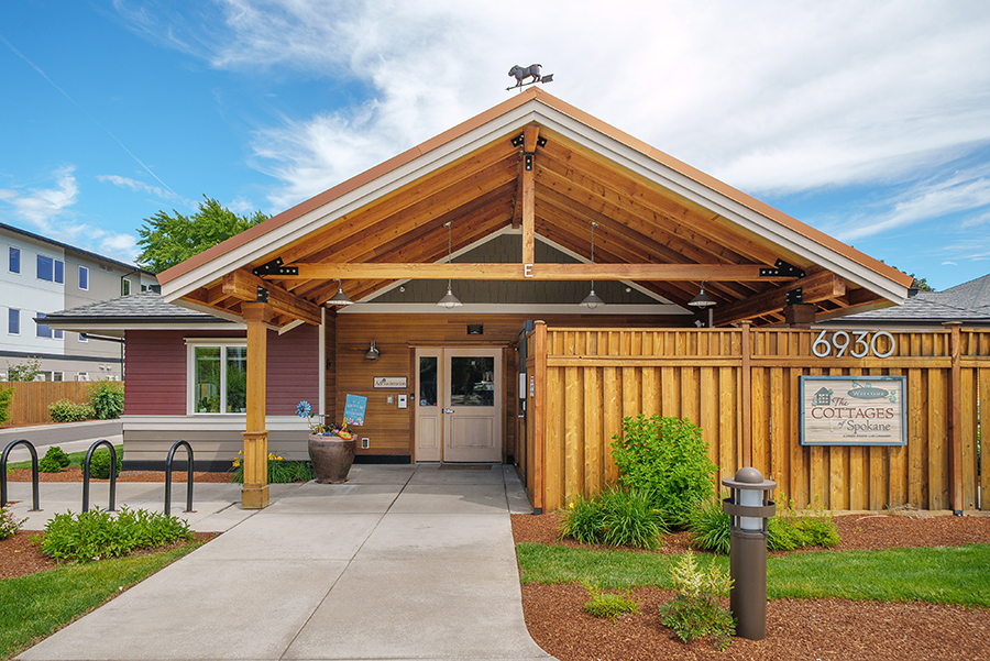 Welcoming entrance to a rustic-style building with landscaping.