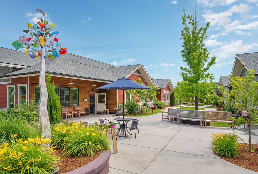Colorful landscaping with modern architecture under a clear sky.