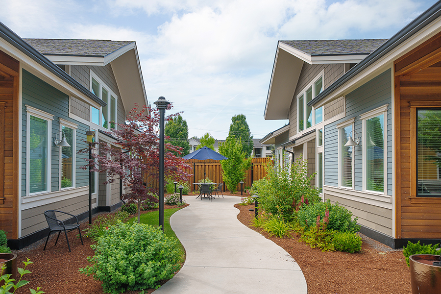 Charming courtyard with pathway and landscaped gardens.