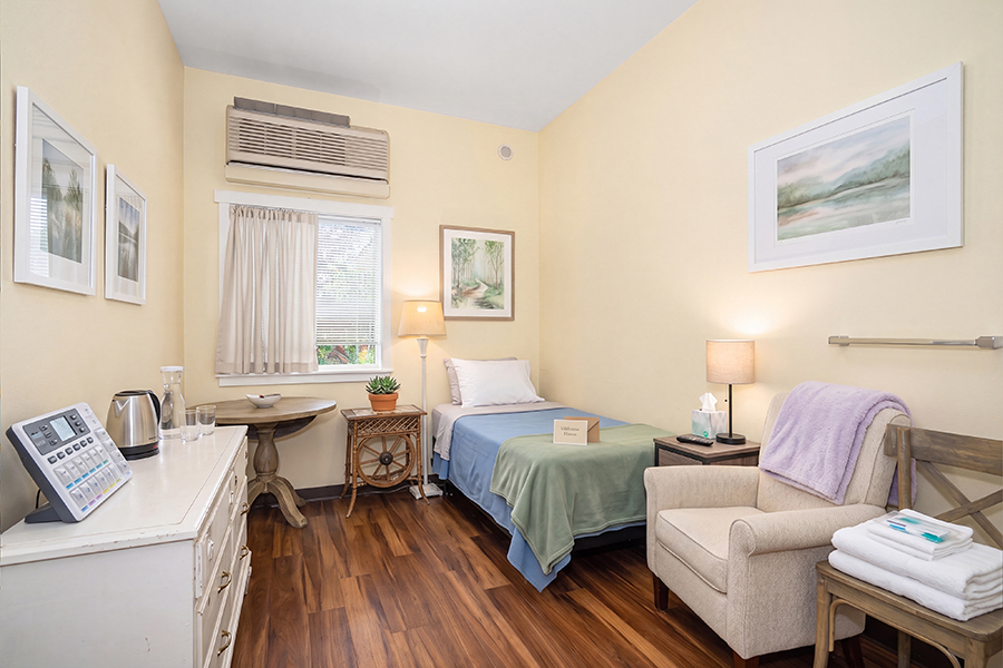 Cozy, well-decorated room with a bed and sitting area.