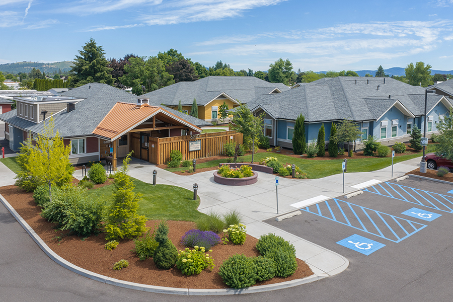 Residential community with landscaping and accessible parking spaces.