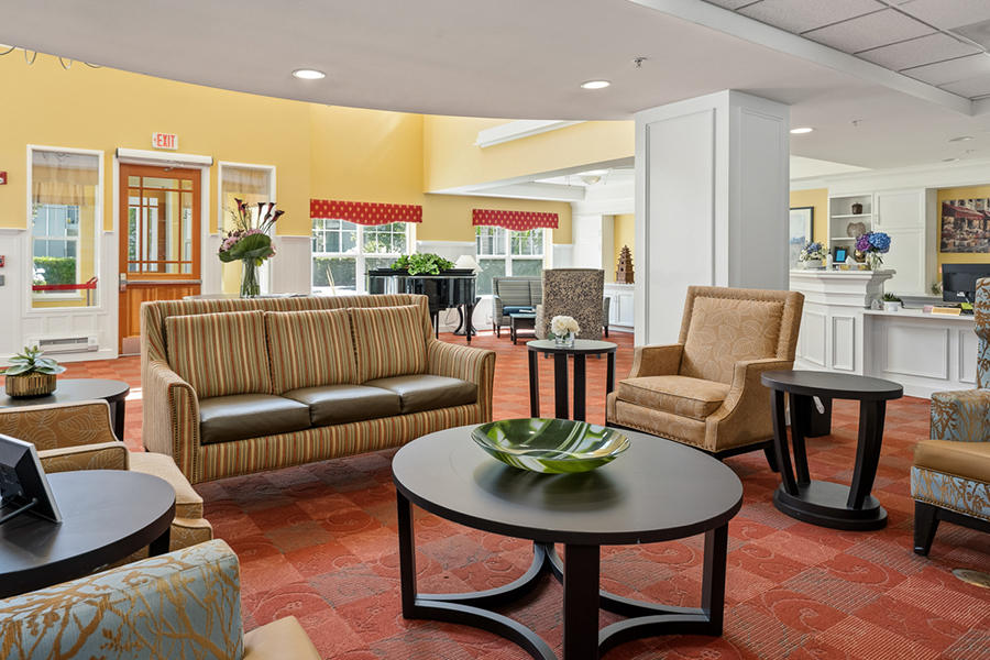 Cozy lounge area with seating and bright yellow walls.
