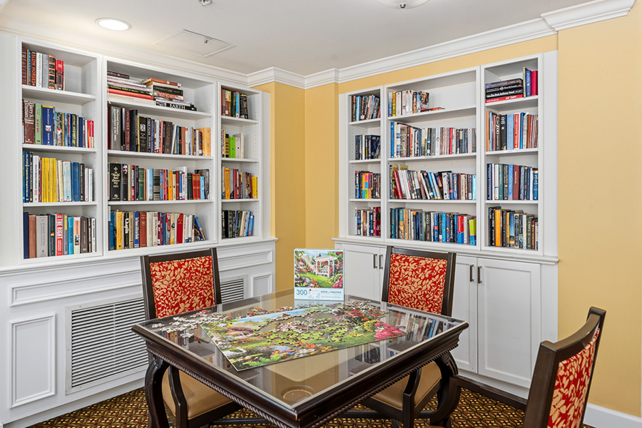 Cozy reading nook with bookshelves and puzzle table.