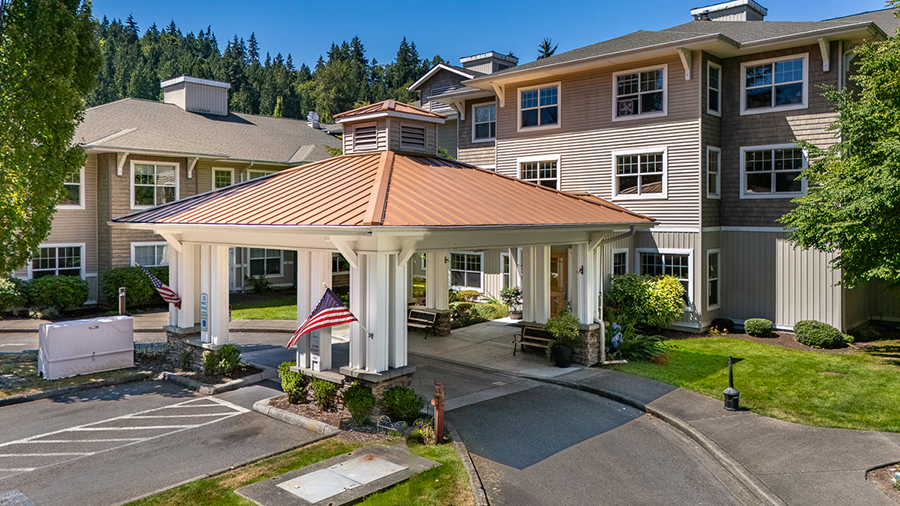 A welcoming building entrance with landscaped surroundings.