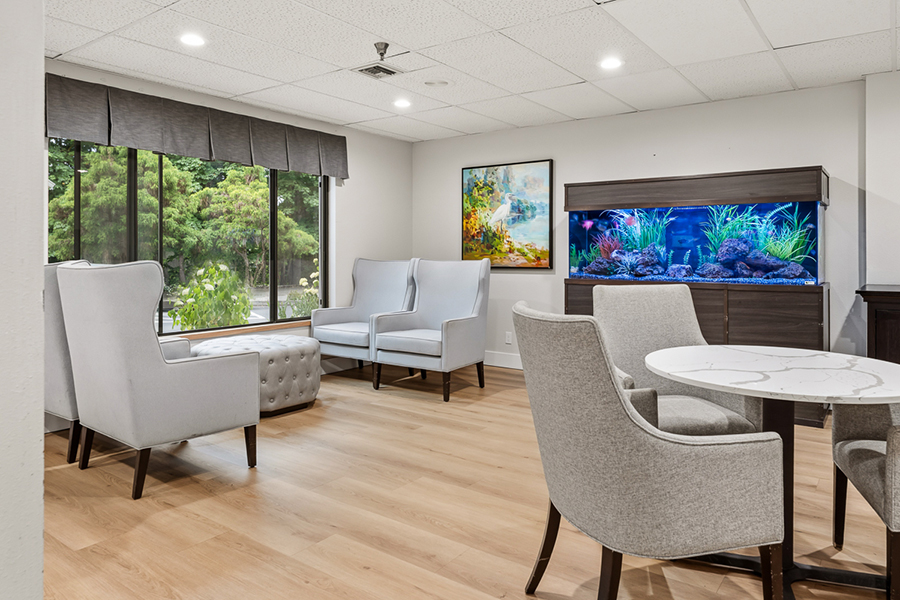 Cozy waiting area with aquarium and comfortable seating.