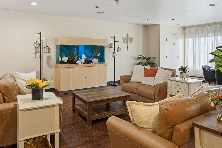 Cozy living room with aquarium and comfortable seating.