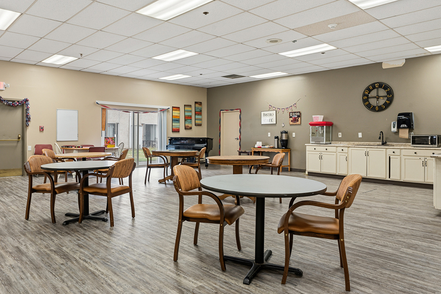 Spacious dining area with tables, chairs, and kitchen amenities.