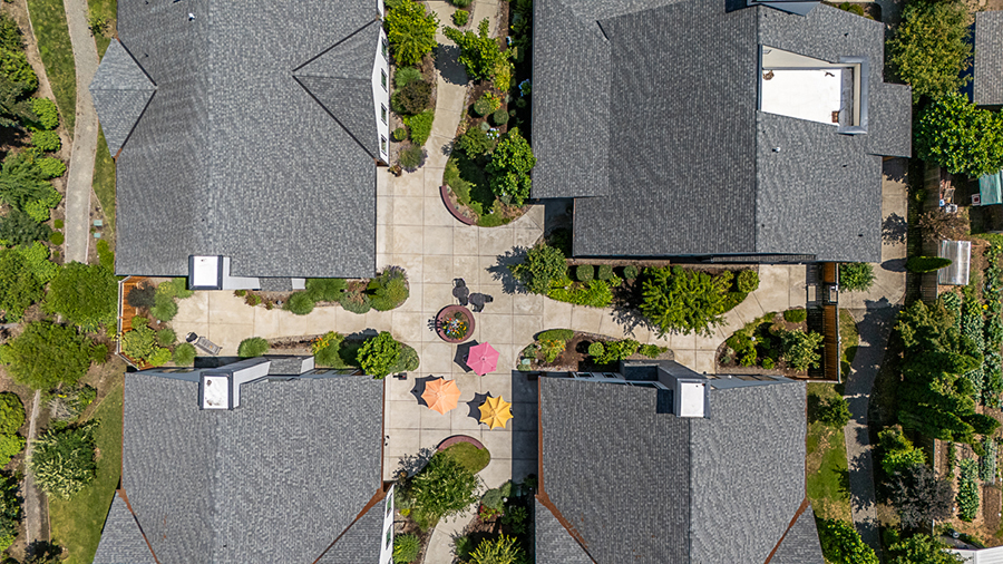 Aerial view of residential complex with landscaped courtyard.