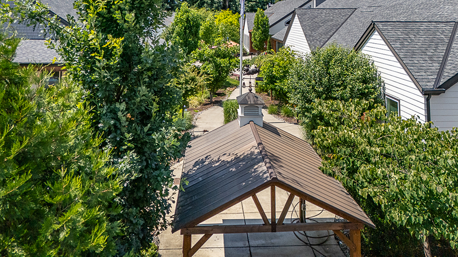 Garden pathway with gazebo and surrounding greenery.