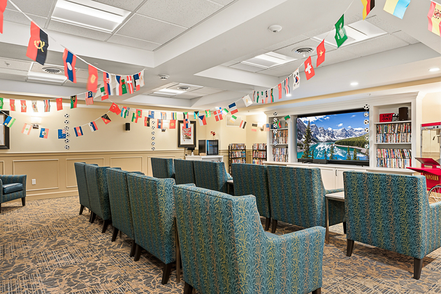 Cozy lounge decorated with international flags and a TV.