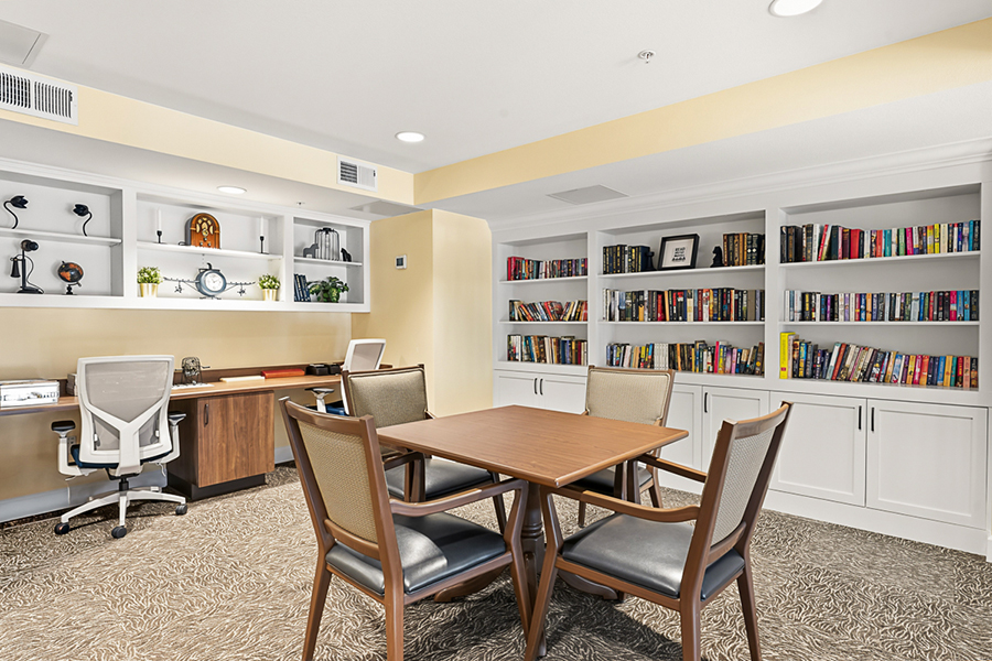 Cozy reading area with bookshelves and workspace table.