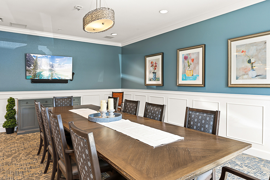 Elegant dining room with decorative art and a TV.