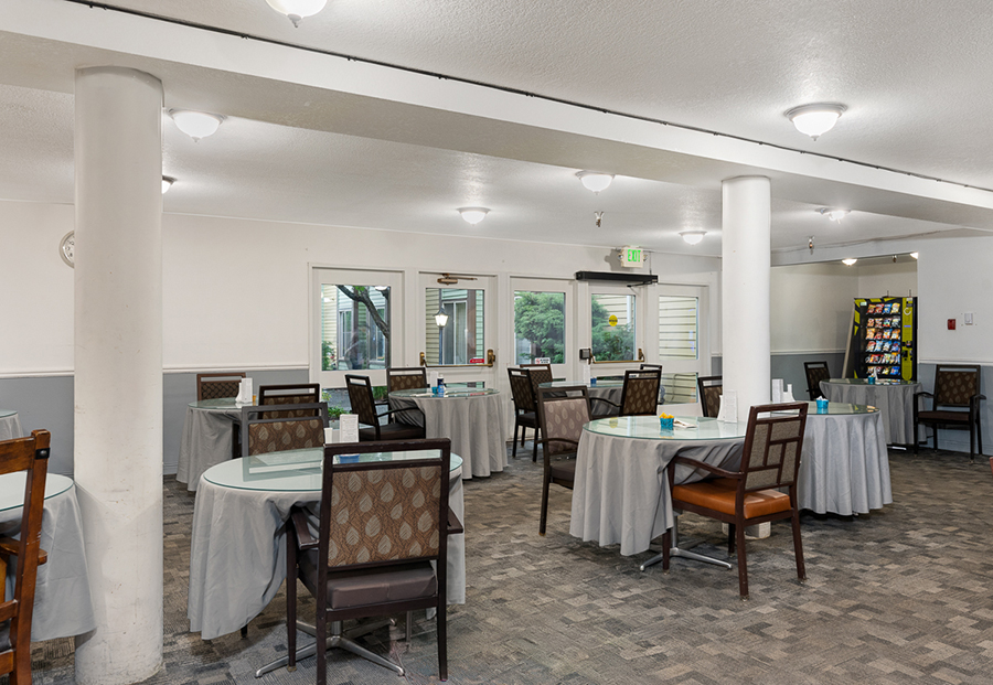 Dining area with round tables and casual seating arrangements.