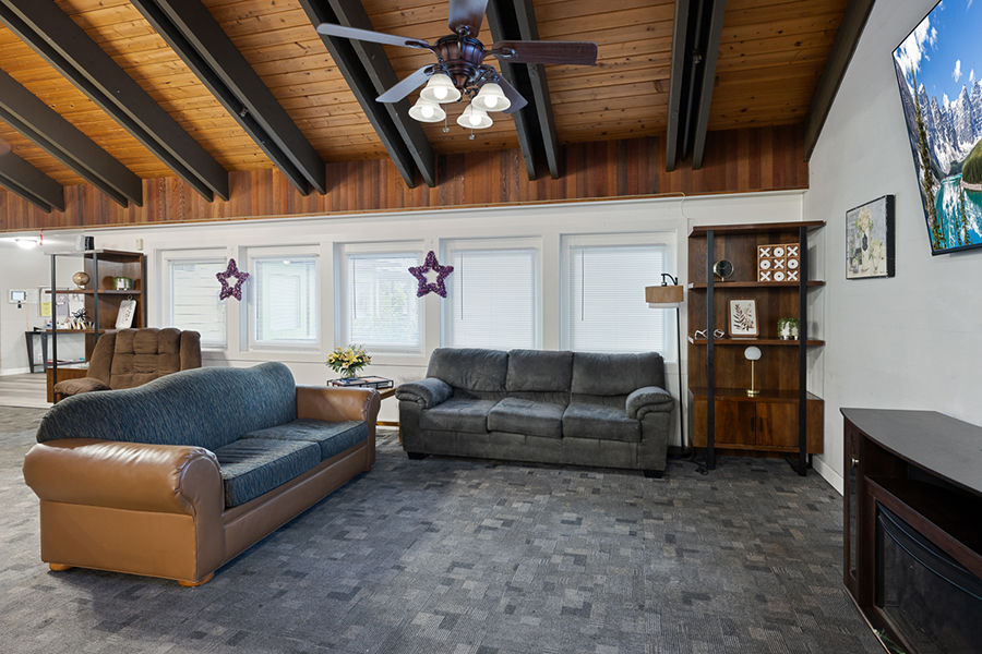 Spacious living room with comfortable seating and wooden accents.
