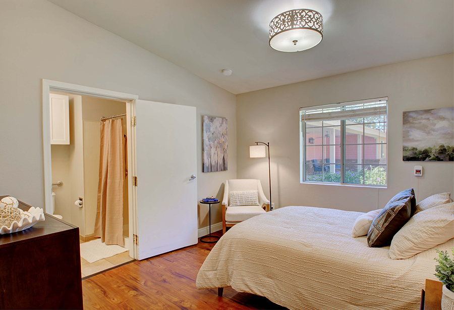 Cozy bedroom with natural light and simple decor.