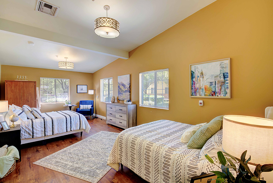 Spacious bedroom with warm colors and modern decor.