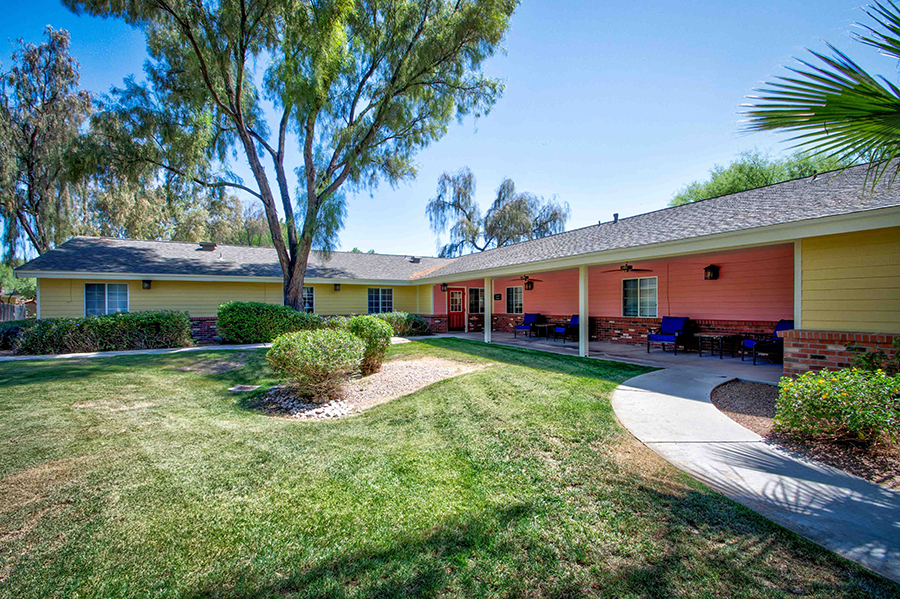 Colorful buildings surrounded by trees and manicured lawn.