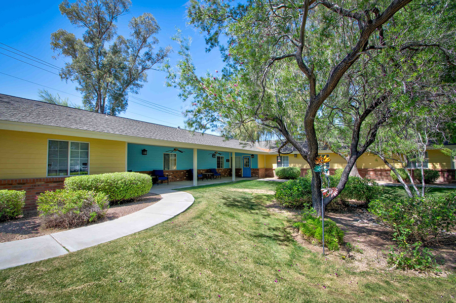 Colorful buildings with green surroundings and pathways.