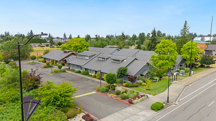 Modern buildings surrounded by lush greenery and landscaping.