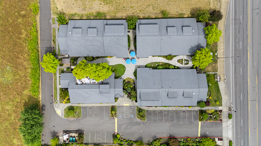 Aerial view of residential buildings with green surrounding.