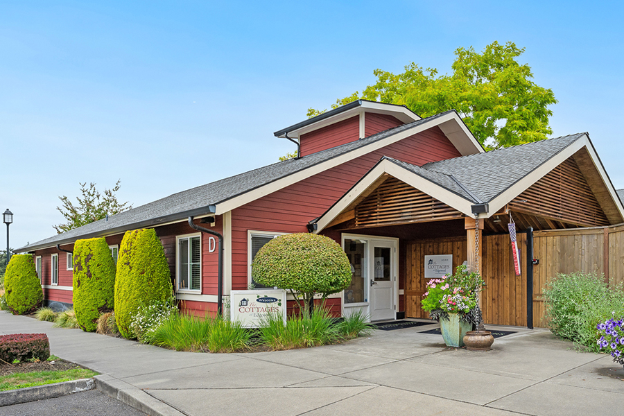 Charming red building with lush greenery and welcoming entrance.