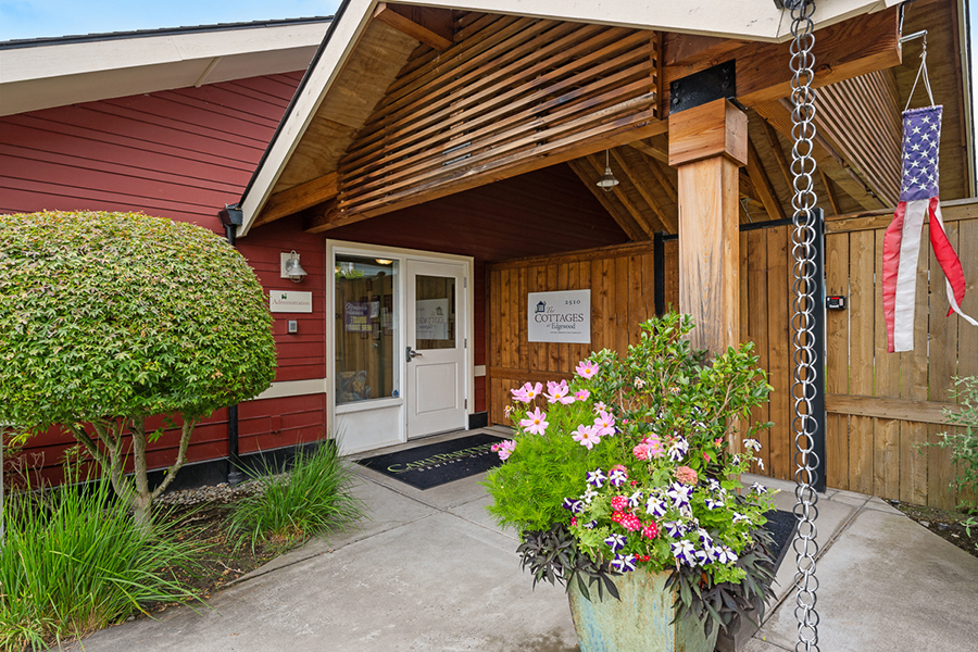 Welcoming entrance with flowers and American flag decor.