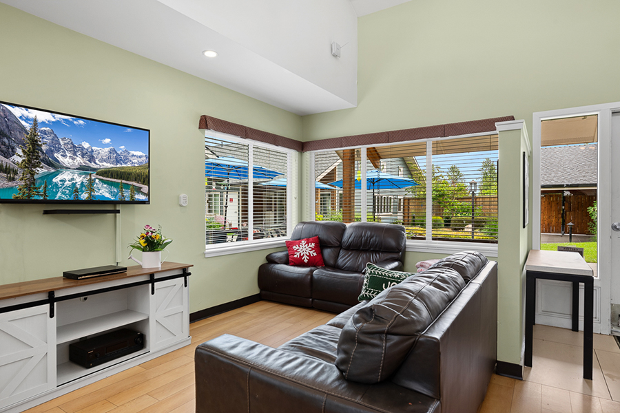 Cozy living room with large windows and modern decor.