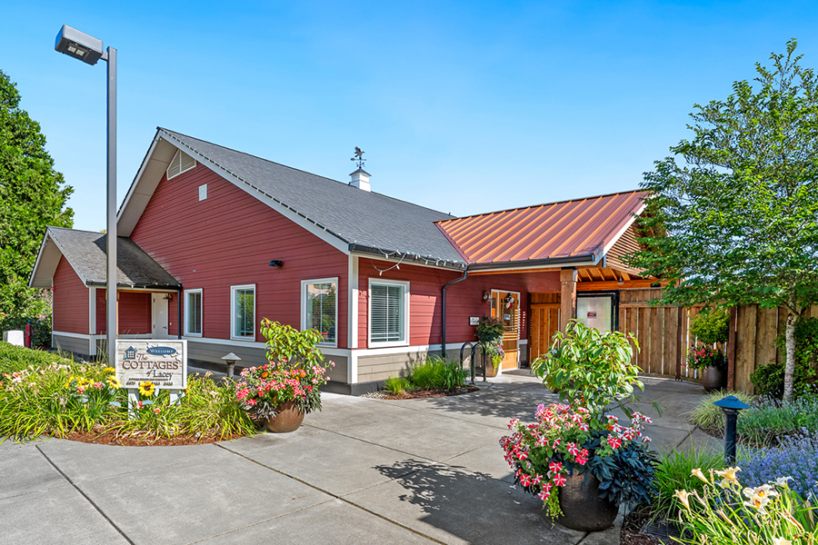 Charming building with flowers and lush landscaping.