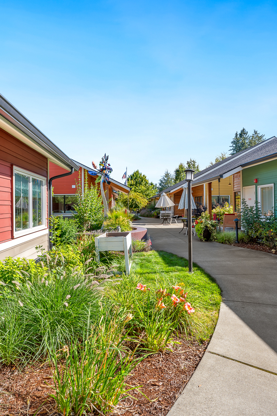 Colorful cottages with lush gardens along a winding pathway.