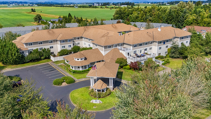 Aerial view of a residential building surrounded by greenery.