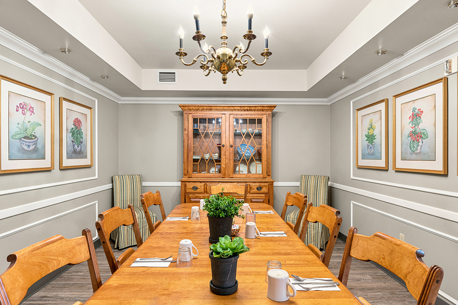 Cozy dining room with wooden furniture and decorative art.